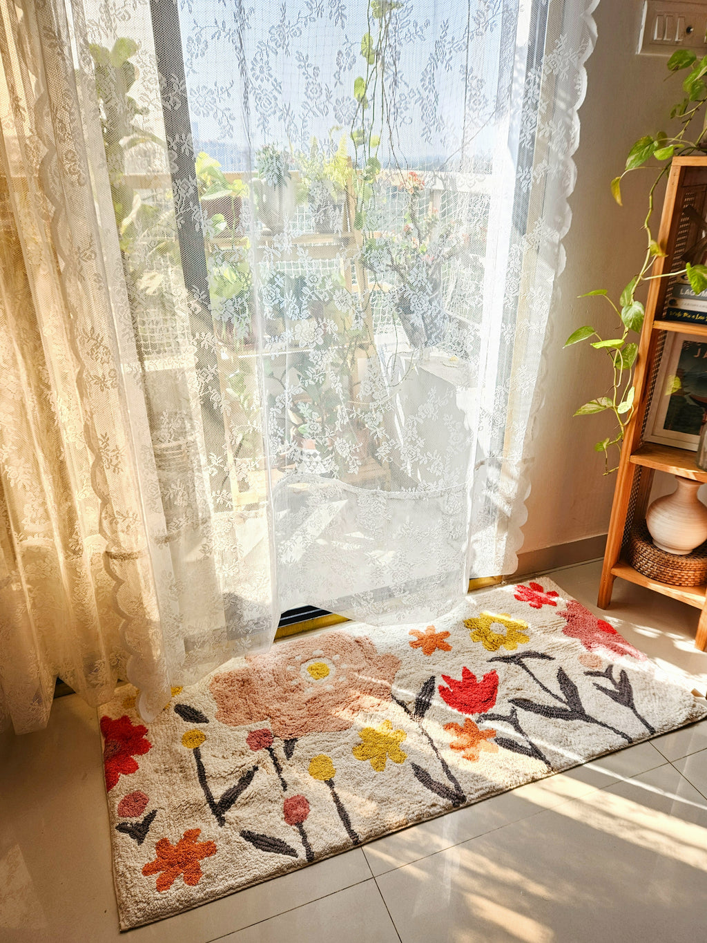 Top-view of the Blossom Trail Rug placed on a wooden floor, showcasing its boho tufted pattern and earthy color palette.

