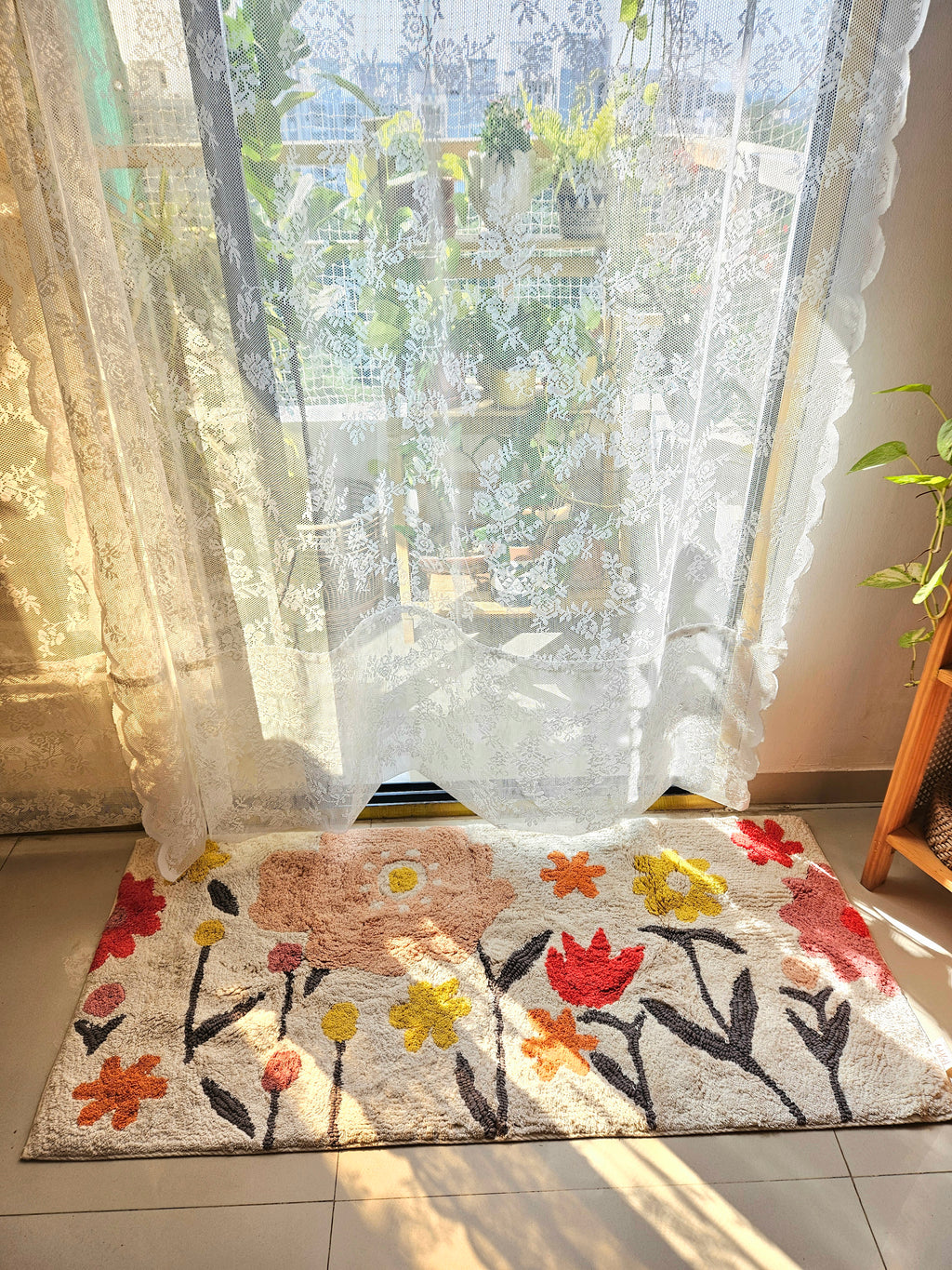 The Blossom Trail Rug under a coffee table, paired with jute accents and bohemian home décor elements.

