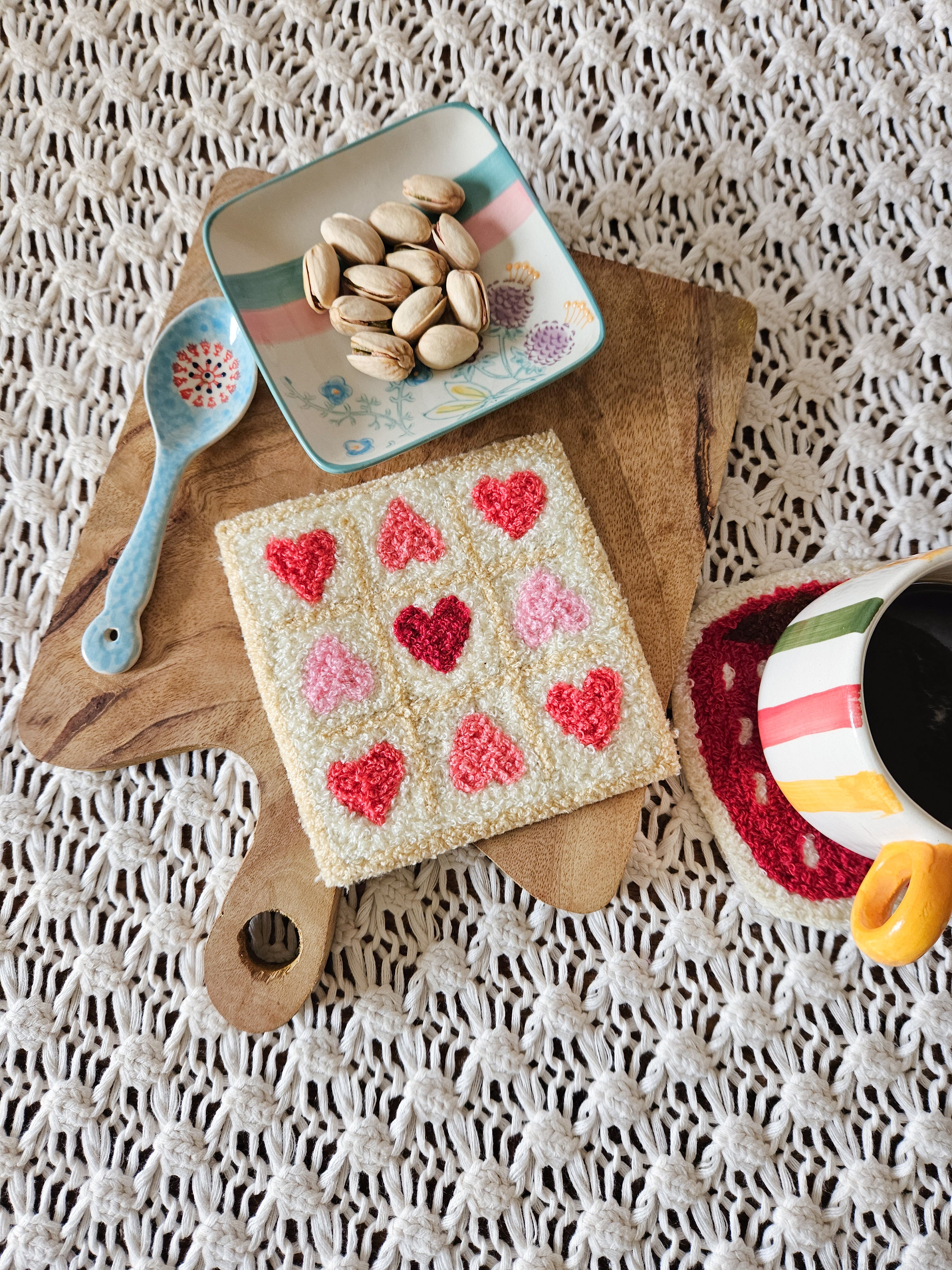Pink and white cotton mug rug with XOXO pattern, displayed on a plain white background

