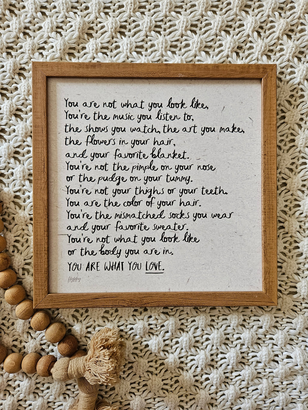 Flat lay of the unframed wall art on a rustic surface, paired with dried flowers, jute fabric, and neutral props.