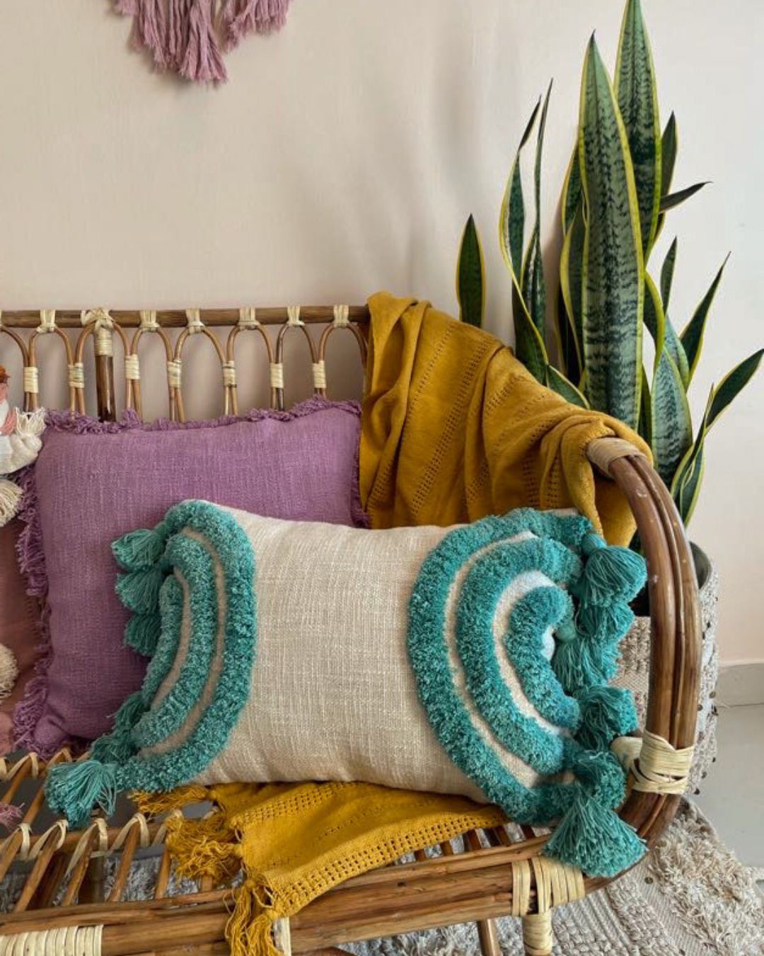 A bohemia-themed tassled and frilled pillow, showcasing its intricate design and earthy, vibrant colors. The decorative fringes and tassels add a touch of whimsical charm to the pillow, creating a unique and inviting decor piece.