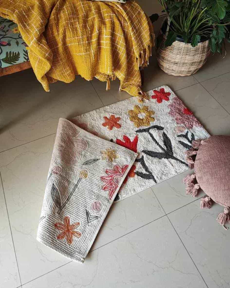 The Blossom Trail Rug rolled up to display its lightweight, flexible cotton weave—ideal for laid-back, boho homes.


