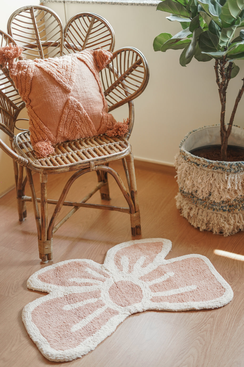 Whimsical bow rug styled on a wooden floor, paired with neutral furniture for a cozy boho vibe.


