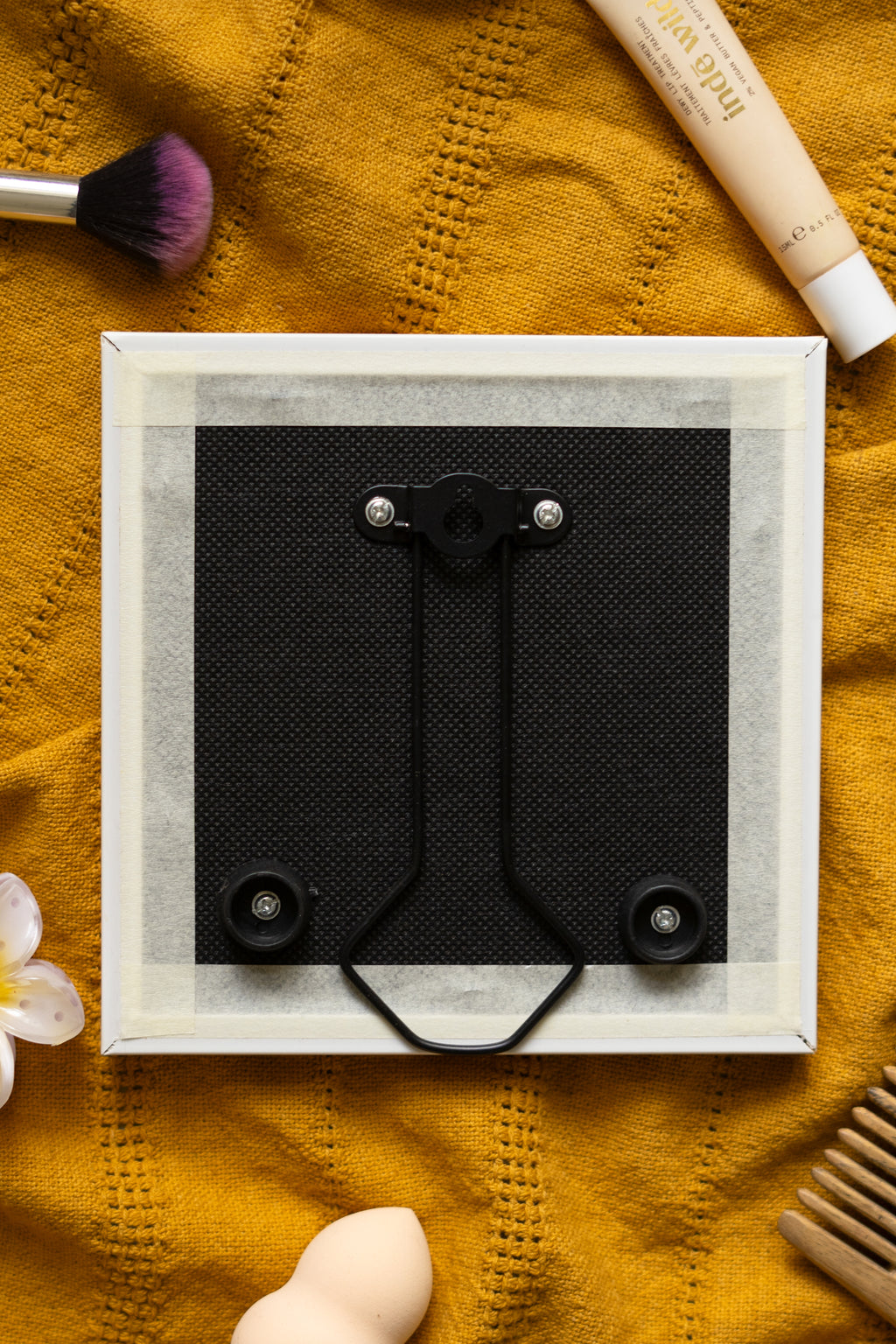 Back view of the framed AM PM print resting against a black cloth, highlighting the frame’s sturdy build and clean finish.

