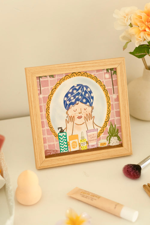 "Framed AM PM print styled above a console table with earthy decor, candles, and soft ambient lighting."

