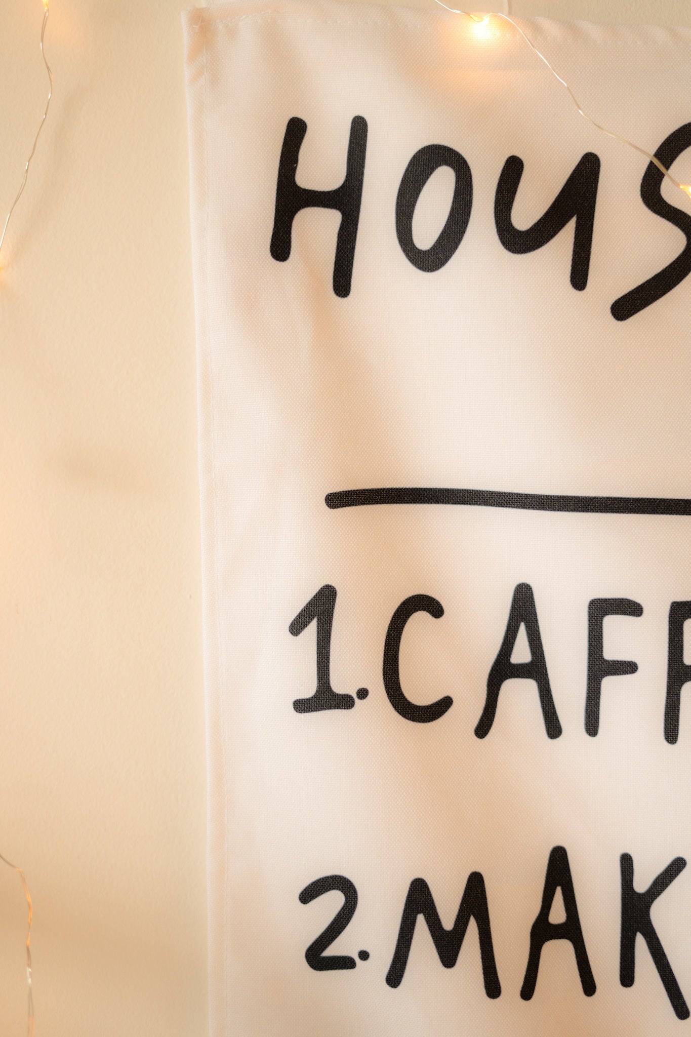 Close-up of the text on “The Boho Code” tapestry, highlighting playful fonts and vibrant, earthy colors.

