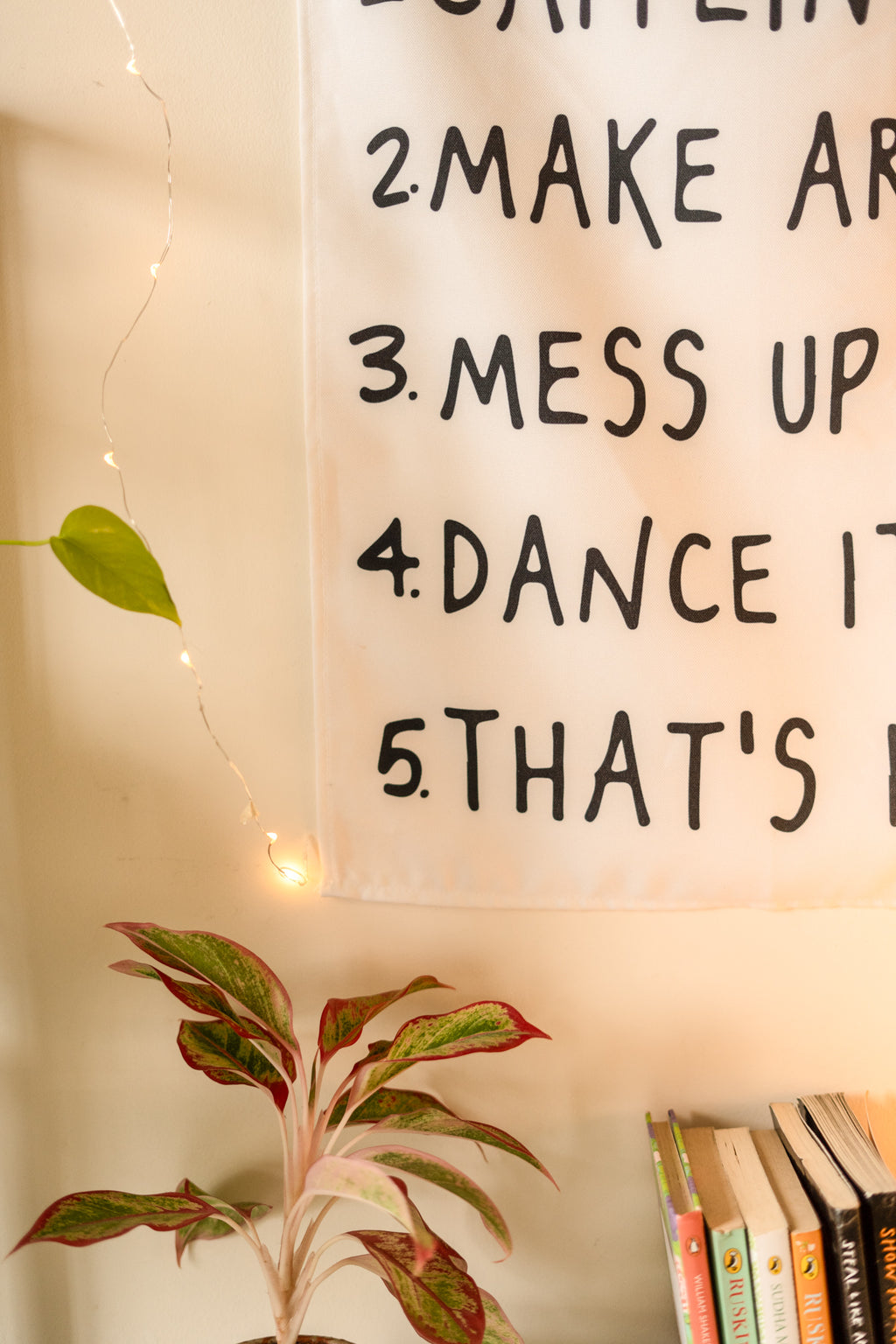 Close-up of the text on “The Boho Code” tapestry, highlighting playful fonts and vibrant, earthy colors.

