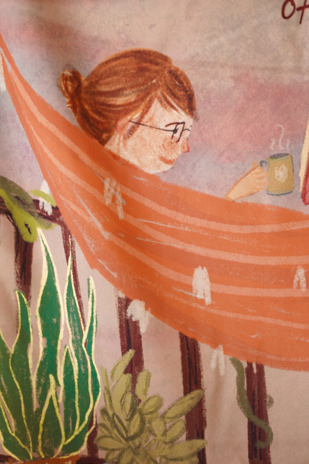 Detailed close-up of black line art featuring croissants, records, coffee cups, and self-care doodles on soft cotton fabric.

